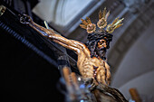 The ornate figure of Cristo del Amor captures attention during Holy Week in Seville, showcasing intricate craftsmanship from 1620.