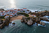 Aerial view of Vestigios do Forte, the rocky cliffs of Baleal Island and local architecture, Portugal