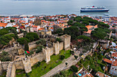 Aerial view of Sao Jorge Castle (Saint George's Castle), city skyline and cruise boat in Lisbon, Portugal