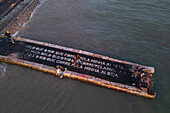 Aerial view of a poem by Alberto Caeiro, one of the heteronyms created by the Portuguese poet Fernando Pessoa, written on a dock of waterside Cais do Sodre, a buzzing nightlife and dining destination in Lisbon, Portugal