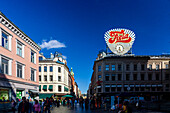 Oslo, Norway, Aug 10 2017, Visitors wander Karl Johans Street in Oslo, enjoying the lively atmosphere and a famous ad display under a clear blue sky.
