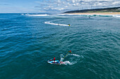 Aerial drone view of Big wave surfing in Praia do Norte (North Beach), listed on the Guinness World Records for the biggest waves ever surfed, formed under the influence of the Nazare Canyon, Portugal