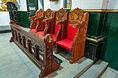 Elaborately carved wooden choir seats in the Cathedral of St. Nicholas in Rionegro, Colombia.