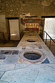 Thermopolium des Vetutius Placidus, Gebäude I.8.8, in den antiken römischen Ruinen von Pompeji, Italien. Ein Thermopolium war ein römisches Schnellrestaurant zum Mitnehmen von Speisen.