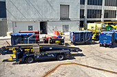 Baggage carts and a mobile baggage conveyor on the apron at the Miami International Airport, Miami, Florida.