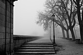 A charming corner in the fog in San Lorenzo de El Escorial, Madrid.