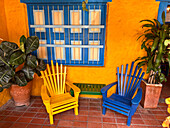 Colorful painted Adirondack chairs on the patio of the Cafe La Manchuria in Peñalisa, Colombia.