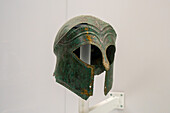 A Corinthian-style bronze helmet in the National Archaeological Museum of Naples, Naples, Italy. From Ruvo, Ruvo, circa late 6th Century B.C. Magna Graecia Collection.