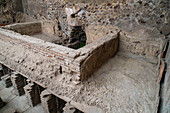 The hypocaust floor supports in the tepidarium in the Stabian Baths in the ancient Roman ruins of Pompeii, Italy.
