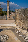 A column & mosaic floor at the House of the Sailor in the ancient Roman ruins of Pompeii in Italy with Mt. Vesuvius behind. Building VII.15.2.