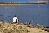 Fisherman at the Santillana Reservoir in Manzanares el Real, Community of Madrid.