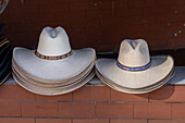 Straw hats for sale in a tourist souvenir shop in El Peñol, Colombia.