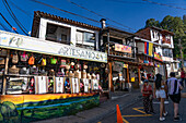 Tourists and souvenir shops on the street in Nueva El Peñol, Colombia.