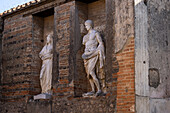 Copies of the original white marble statues in the Macellum or marketplace in the ancient Roman ruins of Pompeii in Italy.
