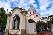 A statue of Mary and the dome of the Cathedral of Salta in Salta, Argentina.