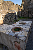 Serving counter of a thermopolium, Building I.7.8, in the ancient Roman ruins of Pompeii, Italy. A thermopolium was a Roman fast-food take-out restaurant.