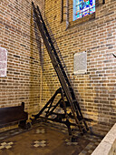 A rolling wooden extension ladder in the Cathedral of Medellín, Colombia, capable of reaching the ceiling.