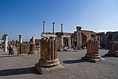 Columns of the Basilica, Building VIII.1.1, looking east toward the Forum in the ancient Roman ruins of Pompeii, Italy.