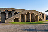 The exterior of the Amphitheater of Pompeii in the ancient Roman ruins of Pompeii in Italy.