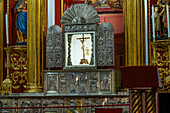 The elaborate silver altar table in front of the main altarpiece in the Cathedral of St. Nicholas in Rionegro, Colombia.