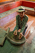 Demonstrartion of the depulped coffee beans with a mortar & pestle, as part of a tour of a coffee farm in Colombia. Prior to 1850, coffee beans were depulped by hand or by mortar and pestle.