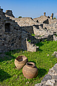 Ceramic pots or dolia in the ruins of a thermopolium, Building VII.16.7, in the ancient Roman ruins of Pompeii, Italy. A thermopolium was a Roman fast-food take-out restaurant.