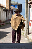 Main square Topaga town. Senior man dressed colombian traditional cloth.