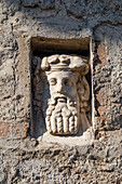 Bust of Dionysus in a niche on the Taberna delle Quattro Divinita, Building IX.7.1, in the ancient Roman ruins of Pompeii, Italy.