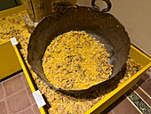 An antique bronze kettle with corn and beans in the Bicentennial Cultural Center, Santiago del Estero, Argentina.
