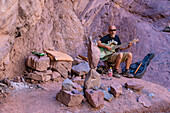 A musician plays the guitar in the Amphitheater or Anfiteatro on RN 68 in the Quebrada de las Conchas, Argentina.