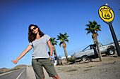 Young Caucasian woman hitchhiking on Route 66