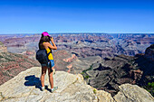 Young caucasian female photographer shooting in Grand Canyon, Arizona