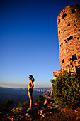Young woman enjoying the sunset views from Grand Canyon Desert View Watchtower, Arizona