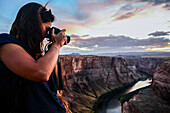 Young caucasian female photographer shooting in Grand Canyon, Arizona