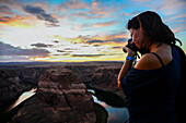 Young caucasian female photographer shooting in Grand Canyon, Arizona