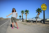 Young Caucasian woman hitchhiking on Route 66