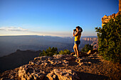 Young caucasian female photographer shooting in Grand Canyon, Arizona