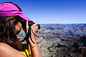 Young caucasian female photographer shooting in Grand Canyon, Arizona