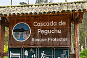 A wooden sign at the entrance to the Cascada de Peguche, Otavalo, Ecuador.
