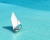 Aerial view of a tropical paradise with turquoise water and boats sailing, Bileyfahi, Shaviyani, Maldives.