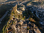 Aerial view of the historic castle of Gjirokaster at sunrise with beautiful stone houses and medieval fortress, Gjirokaster, Albania.
