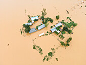 Aerial view of flooded village with submerged houses and waterlogged roads, Jhenaigati, Sherpur, Bangladesh.