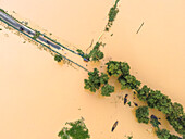 Aerial view of a flooded village with submerged houses and trees, Jhenaigati, Sherpur, Bangladesh.