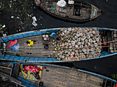 Keraniganj, Bangladesh - 02 February 2025: Aerial view of Buriganga river with boats and a bustling vegetable market, Subhadya, Keraniganj, Dhaka, Bangladesh.
