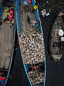 Keraniganj, Bangladesh - 02 February 2025: Aerial view of boats at a vibrant vegetable market along the Buriganga river, Subhadya, Keraniganj, Dhaka, Bangladesh.