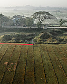 Aerial view of a vibrant cloth factory with people drying cloth amidst a serene rural landscape, Paikar Char, Narsingdi, Dhaka, Bangladesh.