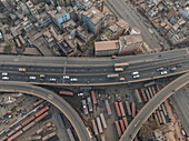 Aerial view of busy junction road with a bus station and dense urban infrastructure, Jatrabari Thana, Dhaka, Bangladesh.