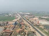 Aerial view of industrial area with buildings, machinery, and vehicles, Uttar Panisar, Sarail, Chattogram, Bangladesh.