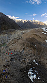 Aerial view of goro2 campsite surrounded by majestic snow-capped mountains and rugged terrain, Skardu, Gilgit Baltistan, Pakistan.