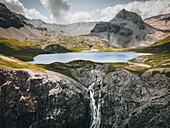 Aerial view of serene alpine landscape with majestic mountains and a tranquil lake, Sta. Maria Val Mustair, Graubunden, Switzerland.